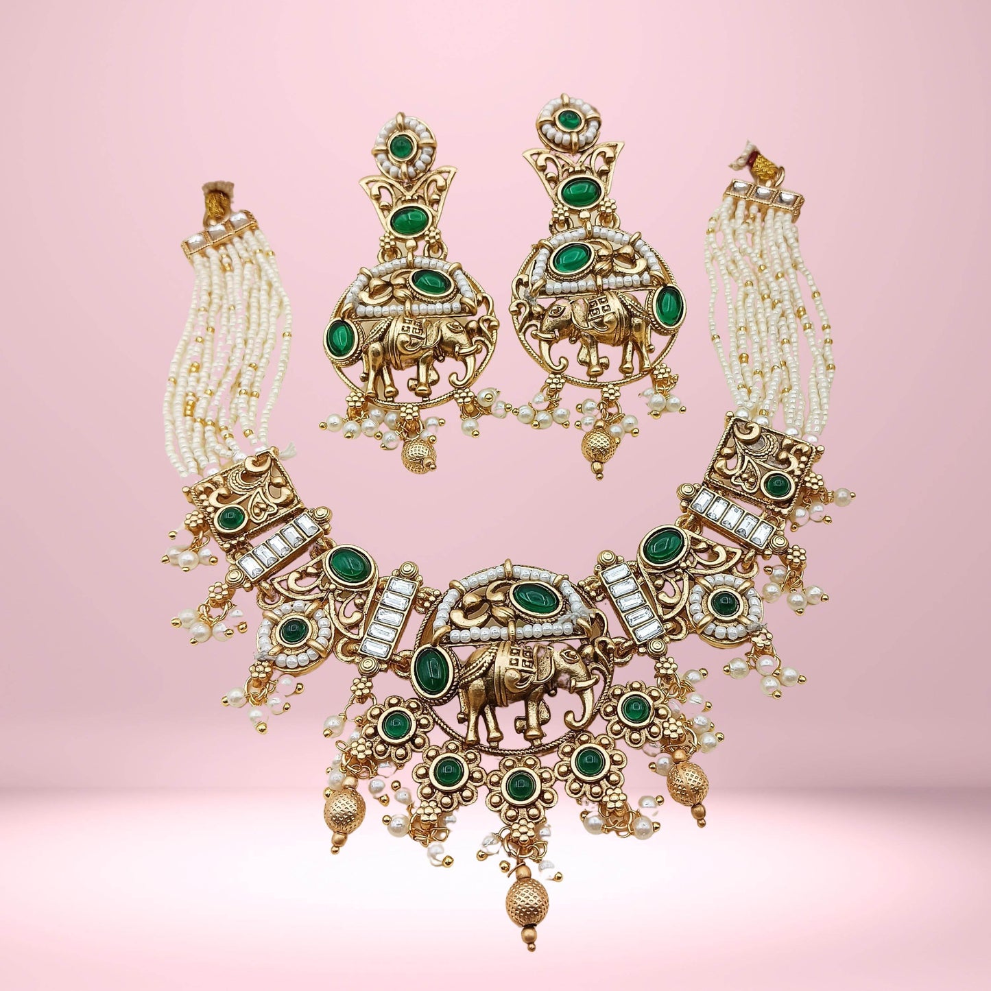 Rajputi elephant design necklace set with green stones and pearl beads on gold finish