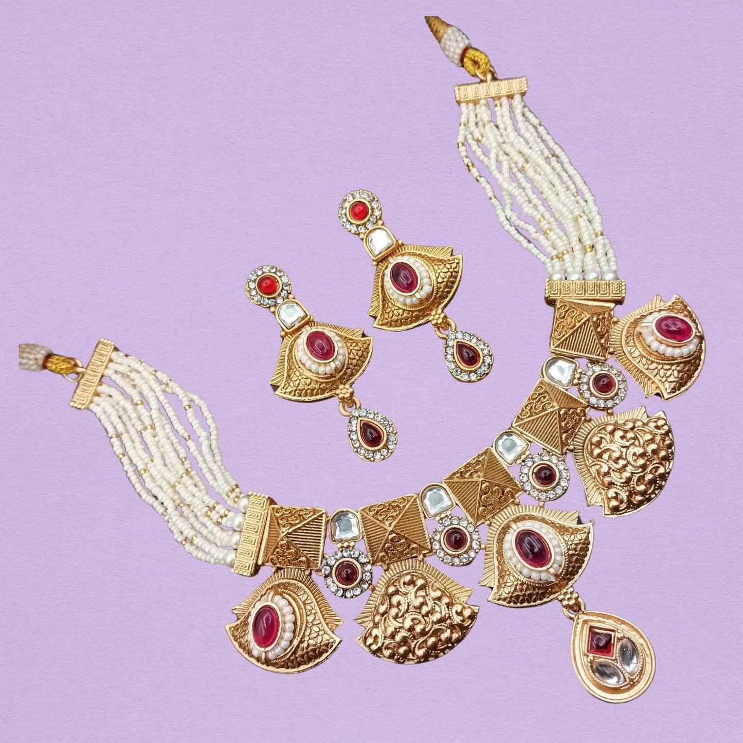 Rajwadi ethnic necklace for women with gold tones, red stones, white beads, and matching earrings