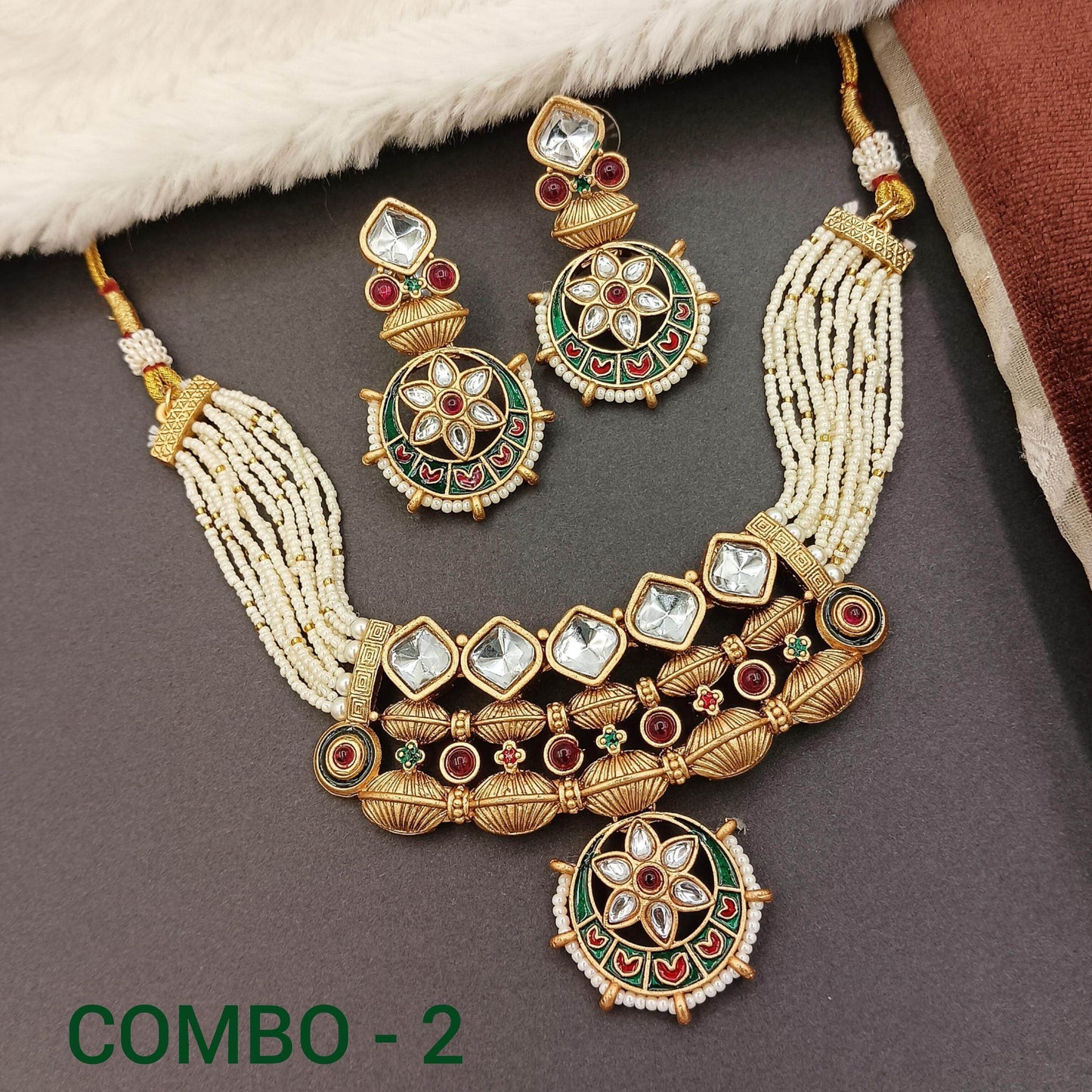 Rajwadi jewelry set for women featuring intricate gold-tone necklace and matching earrings with green and red accents
