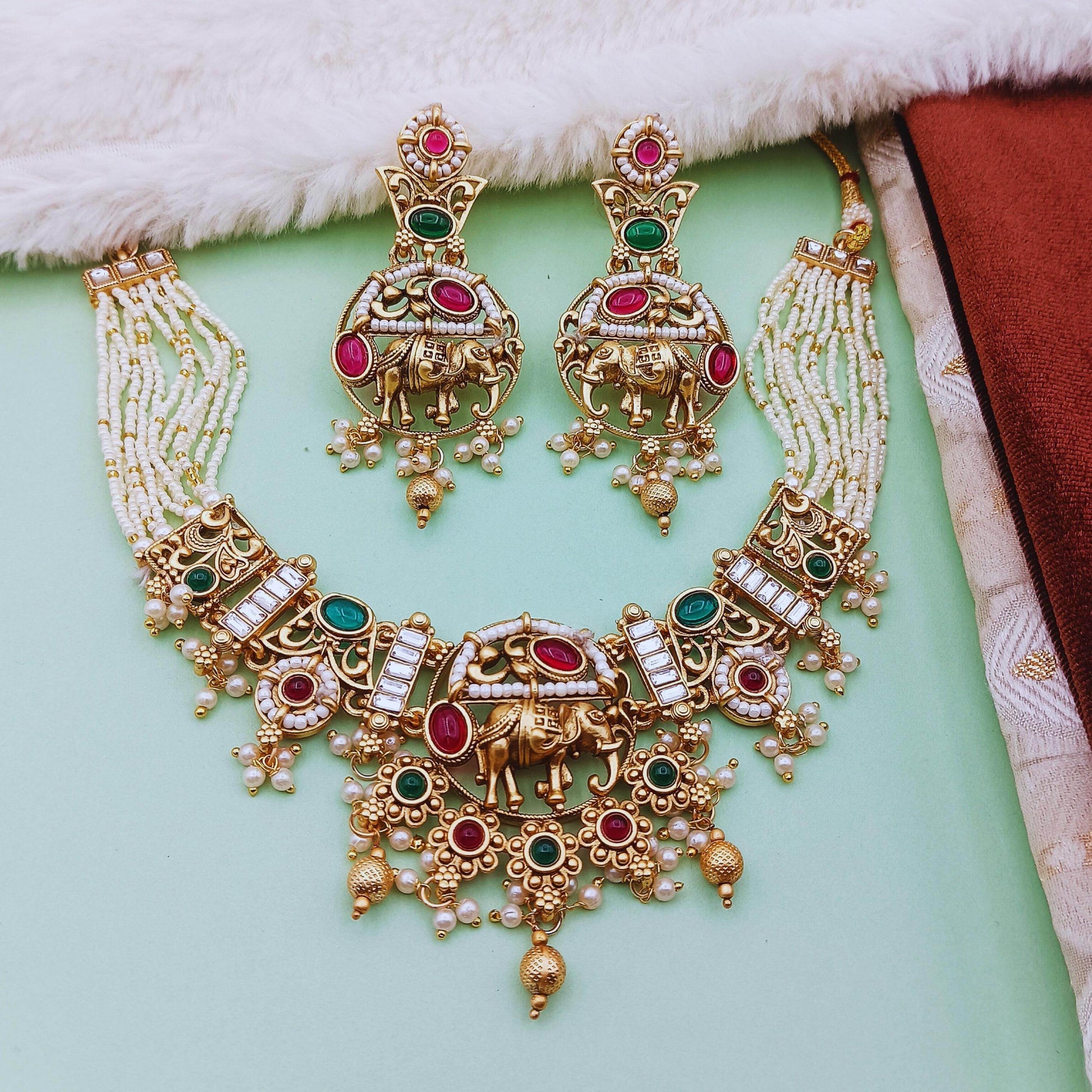 Rajputi elephant design necklace set with green and pink stones and pearl detailing