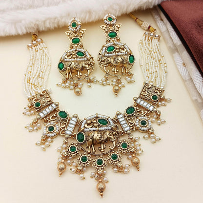 Rajputi elephant design necklace set with green stones and pearl detailing in gold tone