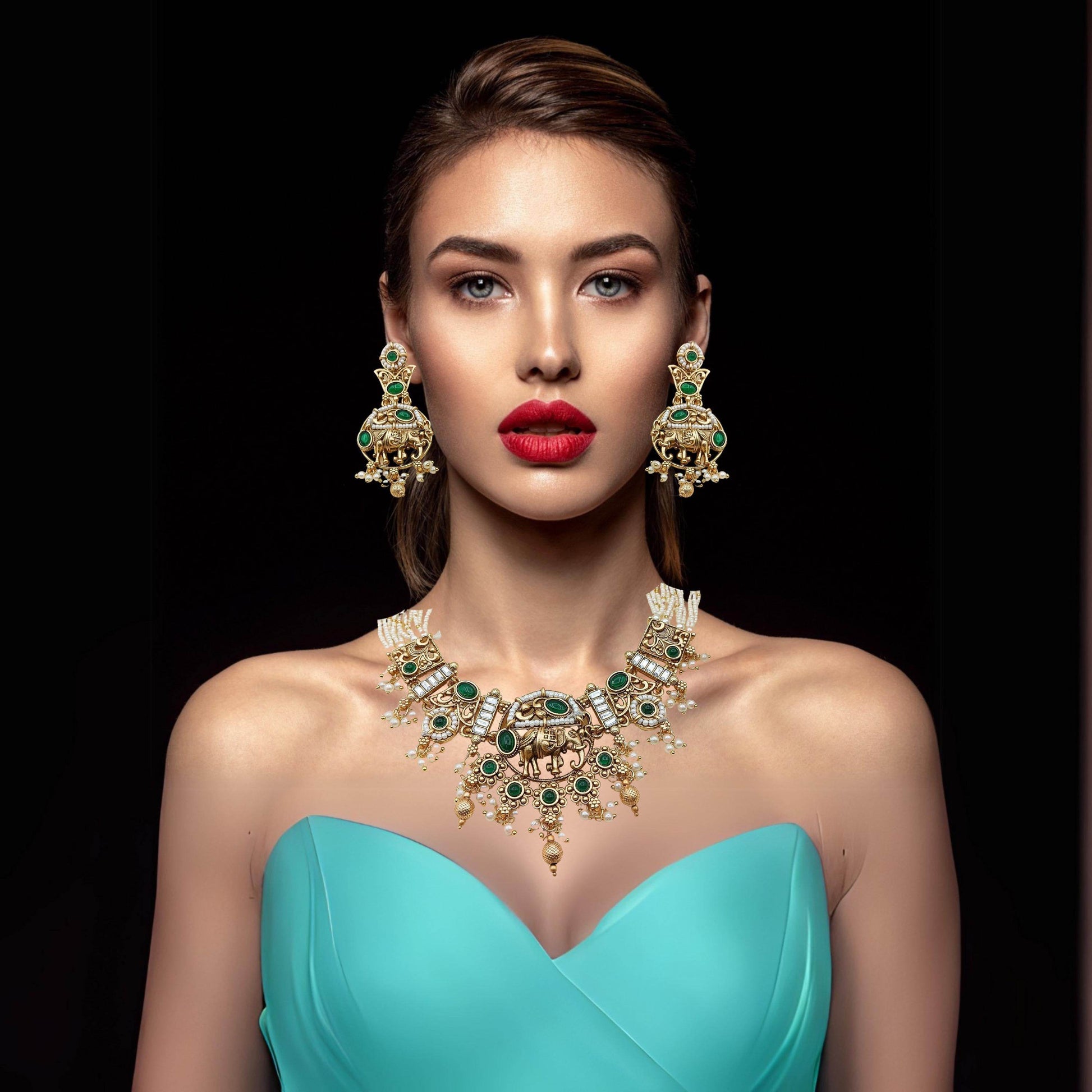 Rajputi elephant design necklace set worn by woman with matching earrings and turquoise dress