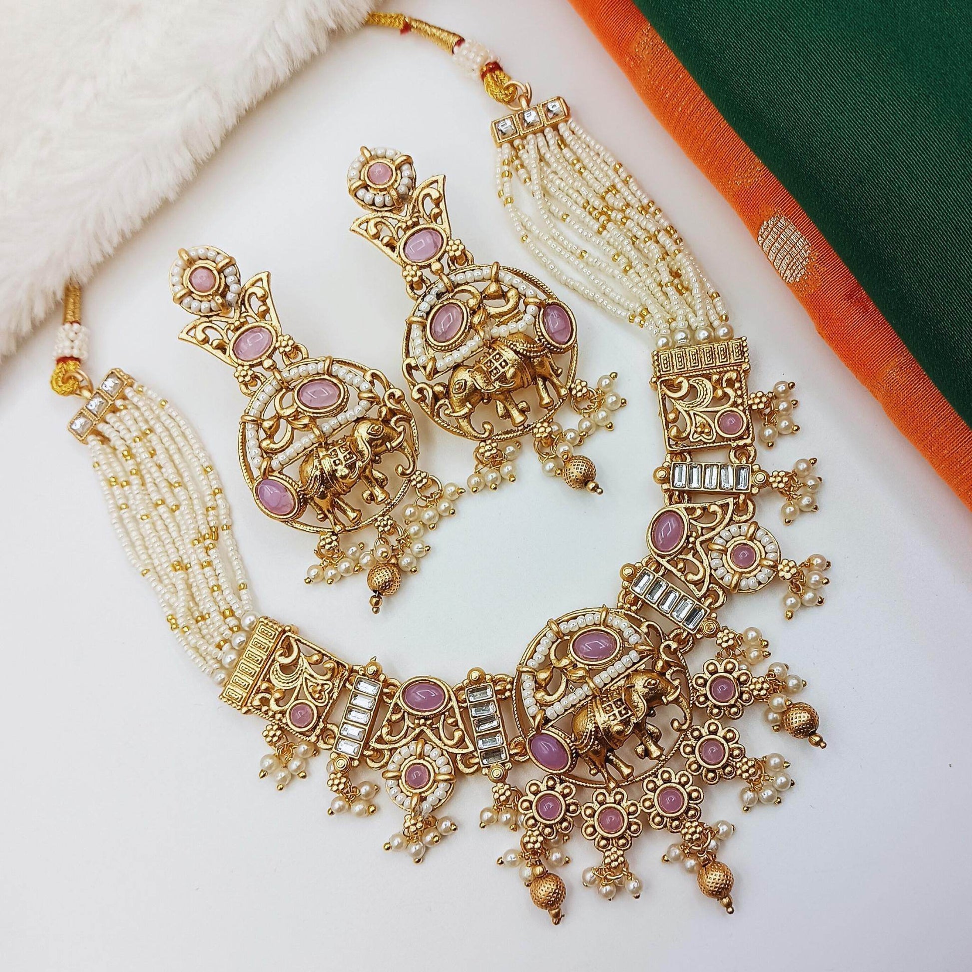 Rajputi elephant design necklace set with gold finish and purple stones featuring intricate pearl details