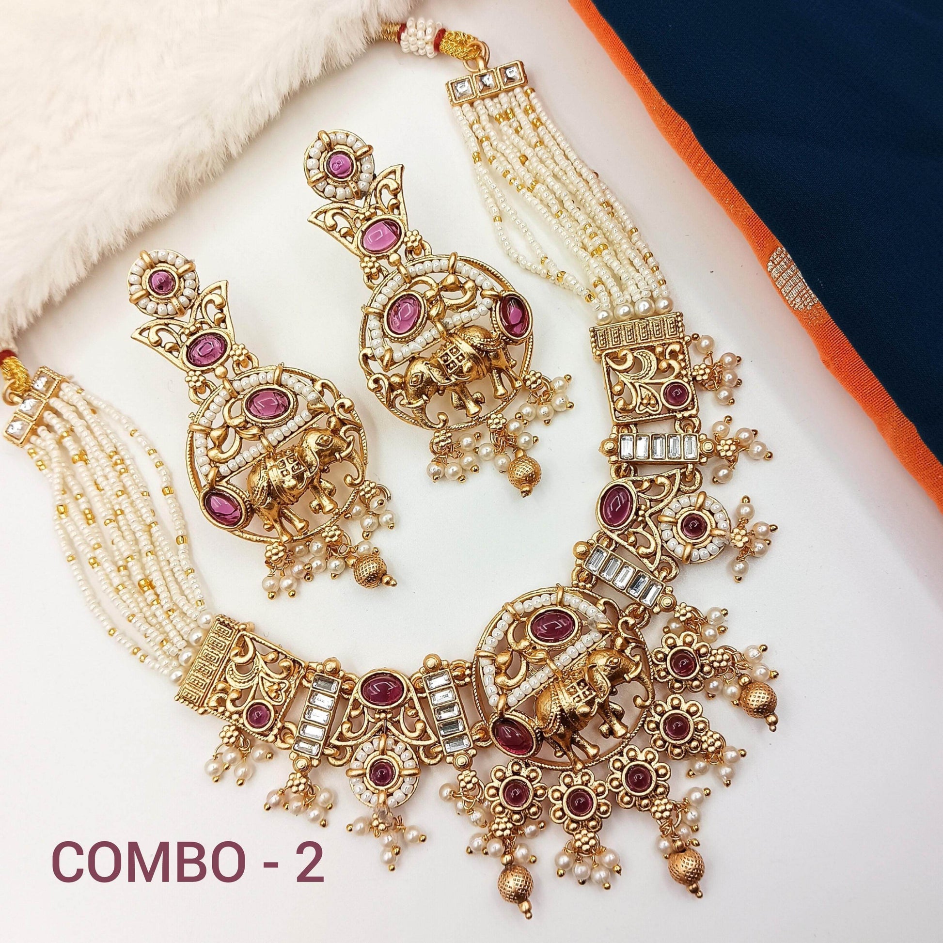 Rajputi elephant design necklace set with intricate gold and purple stone detailing and pearl strands